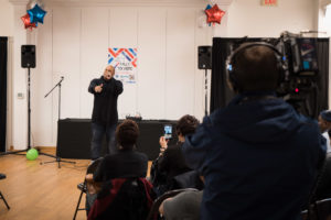Shyan Selah performs in front of audience and news cameras at Rally to Vote